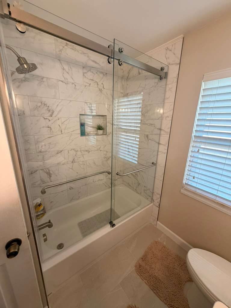 Frameless Sliding Glass Enclosure — bathroom remodel by American Apex Construction