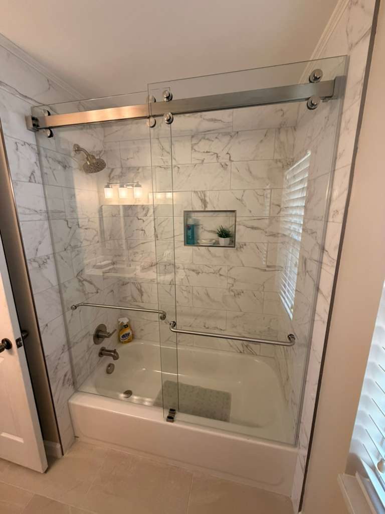 Tub with Frameless Sliding Door — bathroom remodel by American Apex Construction