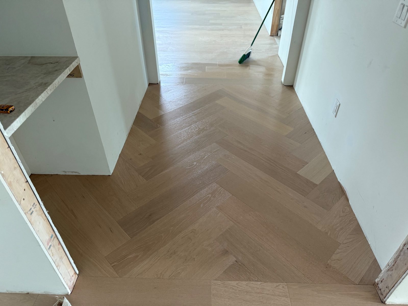 Luxury Herringbone Hardwood Installation — hardwood by American Apex Construction