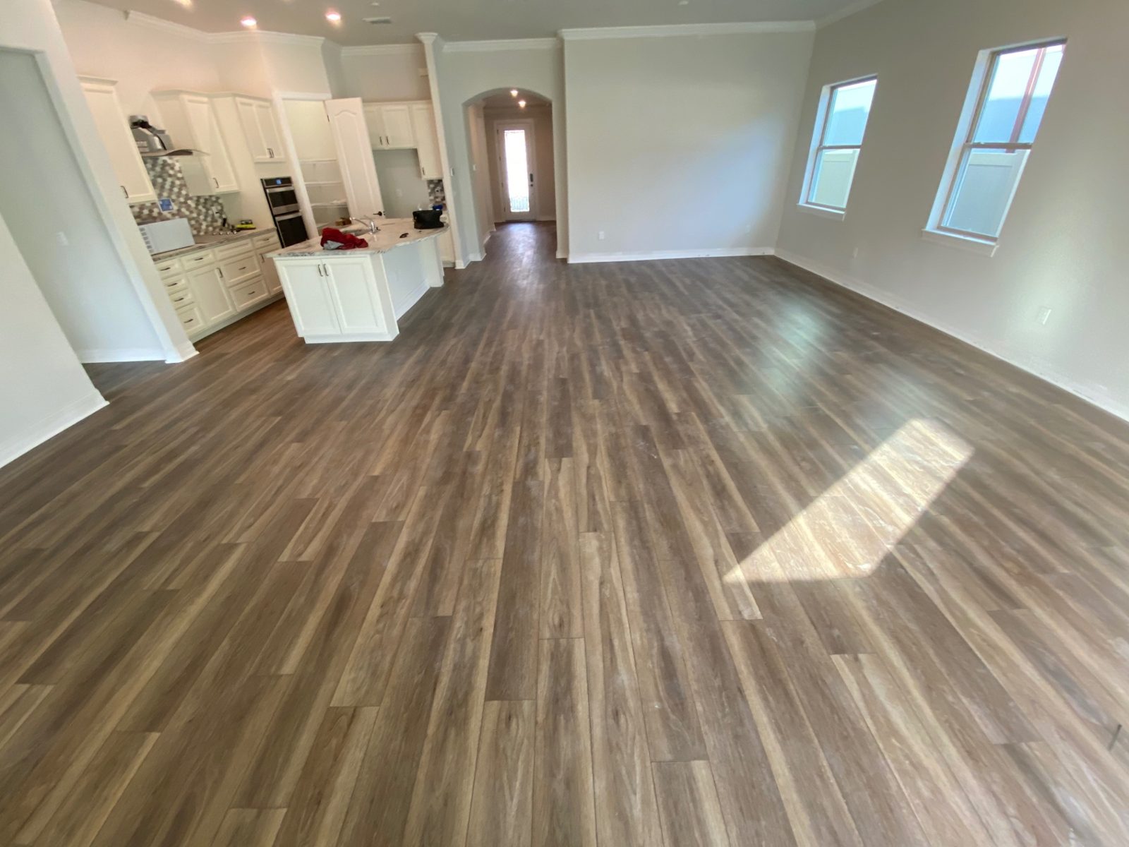 Warm-Tone LVP Kitchen — Vinyl Flooring by American Apex Construction
